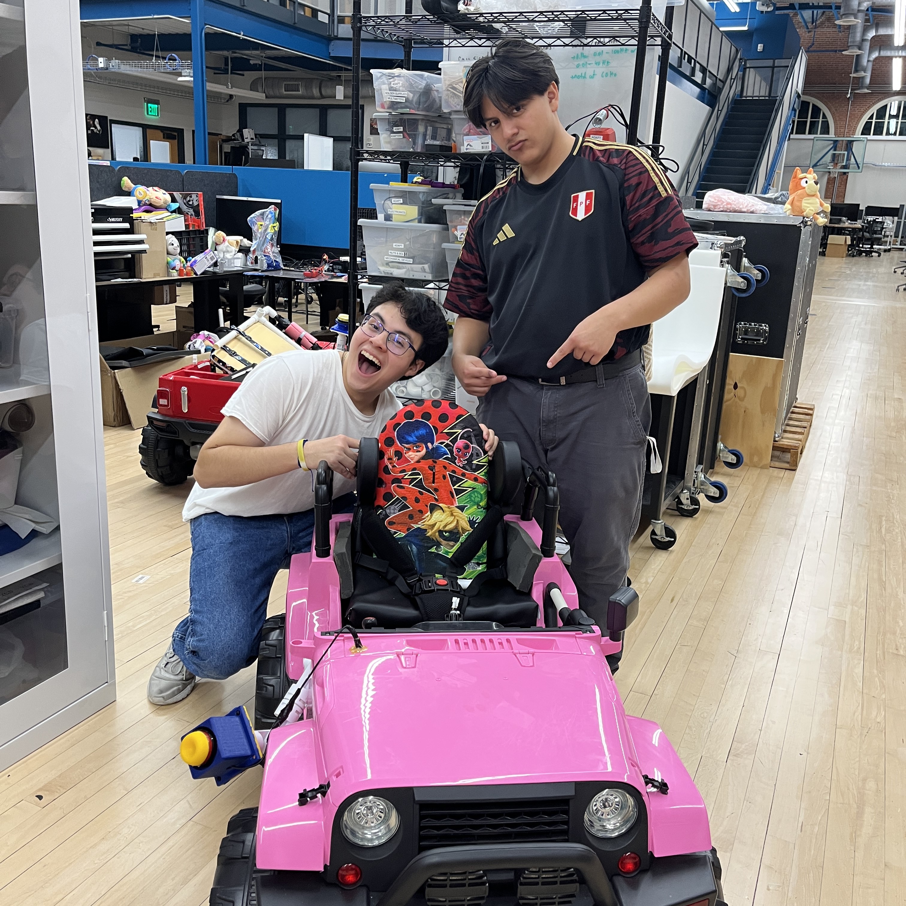 Students collaborating on an adaptive device